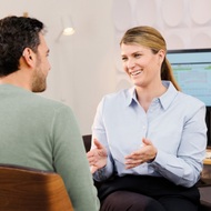Audiologist talking to customer